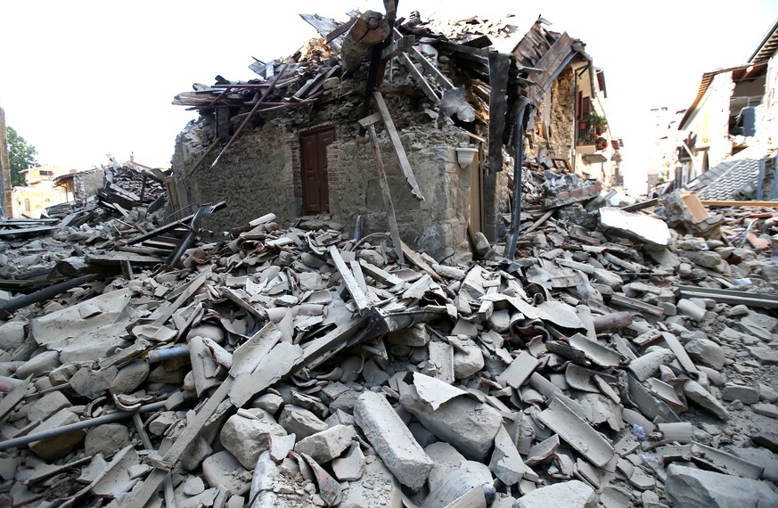 A collapsed house is seen following an earthquake in Amatrice, central Italy, August 24, 2016. REUTERS/Stefano Rellandini