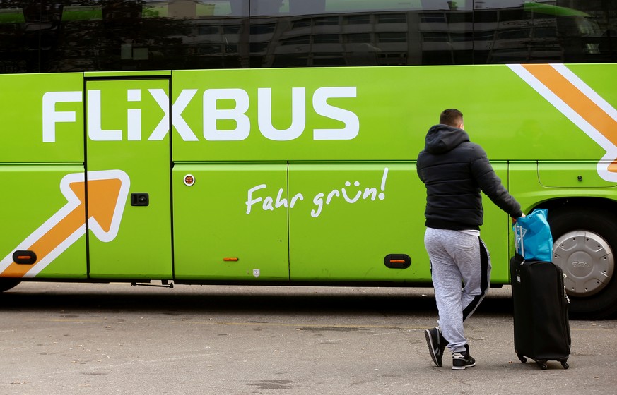 A passenger waits in front of a FlixBus intercity bus at the Carparkplatz Sihlquai bus station in Zurich, Switzerland December 8, 2016. REUTERS/Arnd Wiegmann