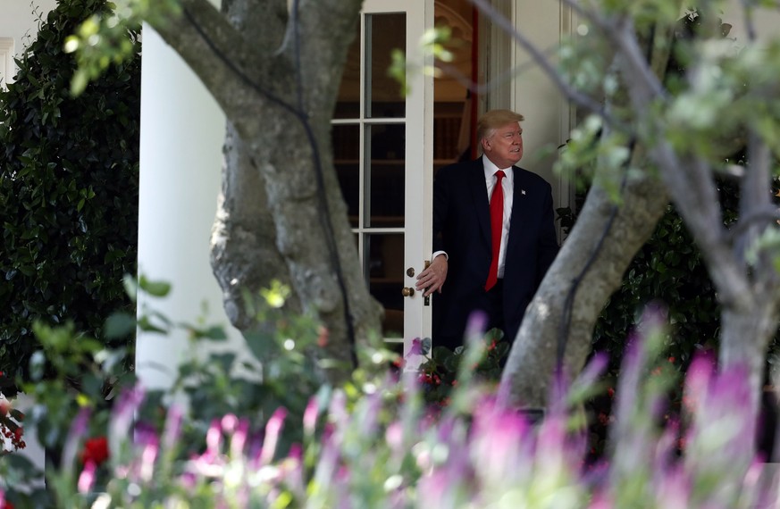 President Donald Trump exits the Oval Office of the White House in Washington, Friday, Aug. 4, 2017, as he walks to Marine One on the South Lawn for a short trip to Andrews Air Force Base, Md. en rout ...