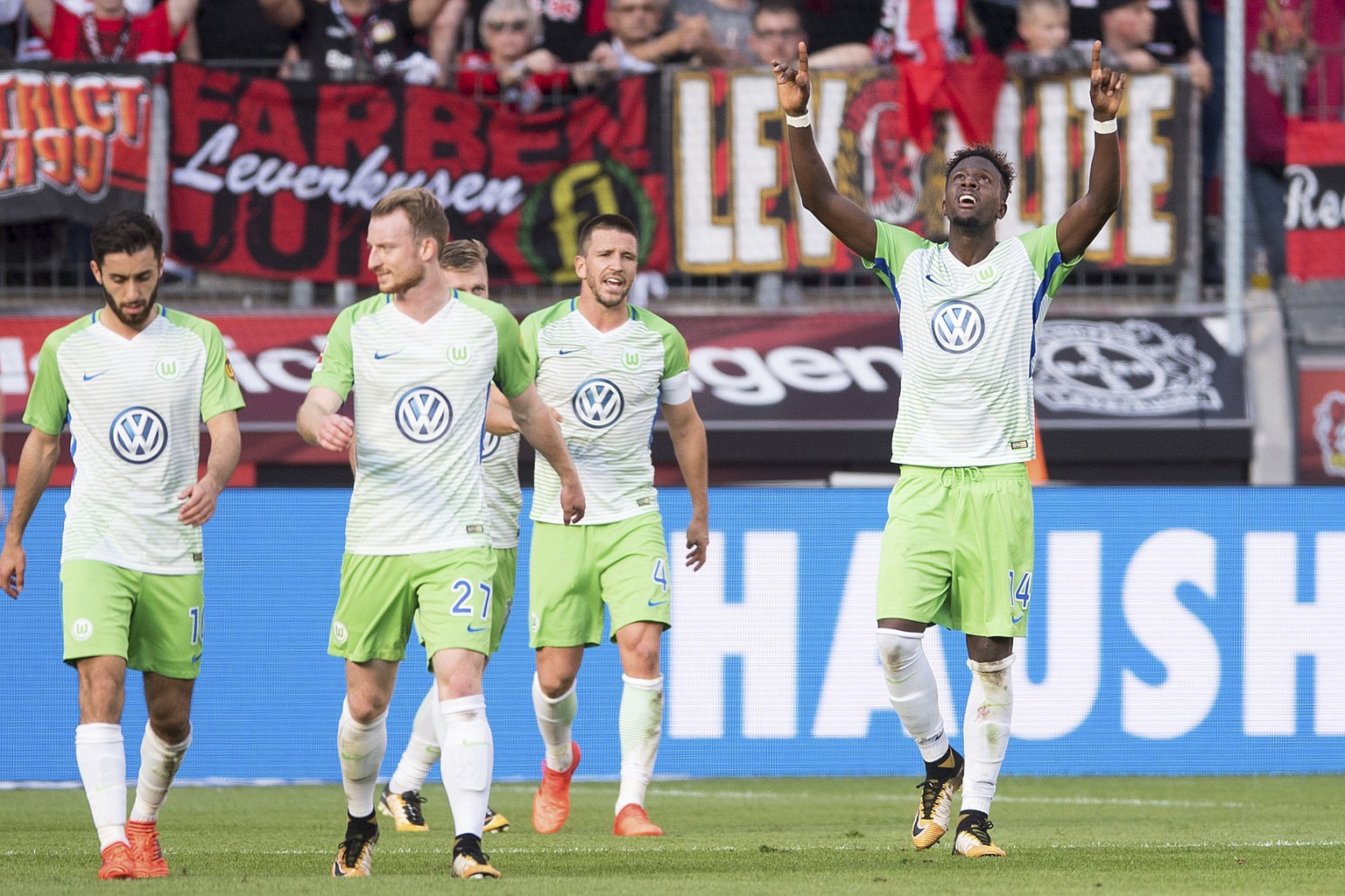 Wolfsburg&#039;s goal scorer Divock Origi , right, celebrates the equalizing 1-1 goal during the German Bundesliga soccer match between Bayer Leverkusen and VfL Wolfsburg in Leverkusen, Germany, Sunda ...