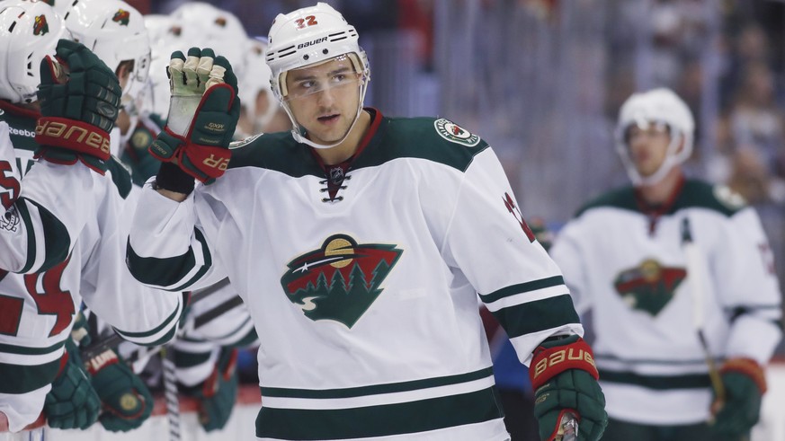 Minnesota Wild right wing Nino Niederreiter, of the Czech Republic, is congratulated as he passes the team box after scoring against the Colorado Avalanche during the third period of an NHL hockey gam ...
