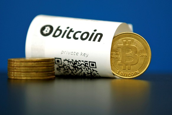 FILE PHOTO: A Bitcoin (virtual currency) paper wallet with QR codes and a coin are seen in an illustration picture taken at La Maison du Bitcoin in Paris, France May 27, 2015. REUTERS/Benoit Tessier/F ...