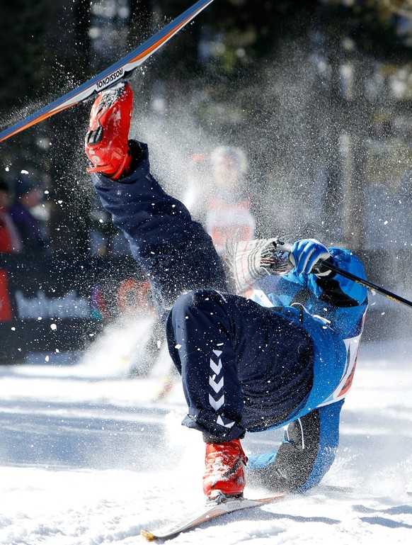 A participant tumbles by a downhill in the Stazerwald near St. Moritz, during the annual Engadin cross-country skiing marathon from Maloja to S-Chanf in south Eastern Switzerland, Sunday, March 14, 20 ...