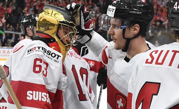 Switzerland’s goaltender Leonardo Genoni, left, and Gaetan Haas celebrate their victory after their Ice Hockey World Championship group B preliminary round match between Switzerland and Canada in Pari ...