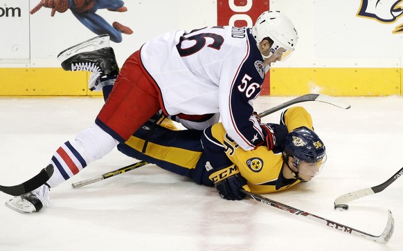 Columbus Blue Jackets center Marko Dano, top, lands on top of Nashville Predators center Kevin Fiala, of Switzerland, in the second period of a preseason NHL hockey game Monday, Sept. 29, 2014, in Nas ...