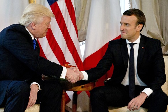 epa05989023 US President Donald J. Trump shakes hands with French President Emmanuel Macron (R) during a meeting on the sidelines of the NATO (North Atlantic Treaty Organization) summit, at the US amb ...