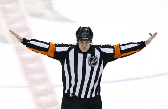 After consulting with the video judge, referee Dave Jackson waves off an apparent goal by Vancouver Canucks&#039; Henrik Sedin, of Sweden, against the Phoenix Coyotes during the third period of an NHL ...
