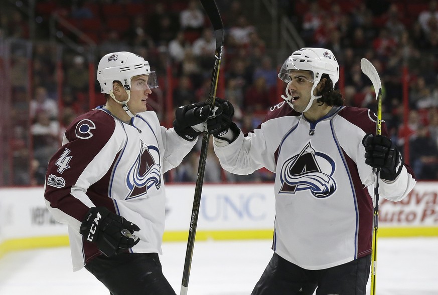 Colorado Avalanche&#039;s Tyson Barrie (4) is congratulated by Mark Barberio following Barrie&#039;s goal against the Carolina Hurricanes during the first period of an NHL hockey game in Raleigh, N.C. ...