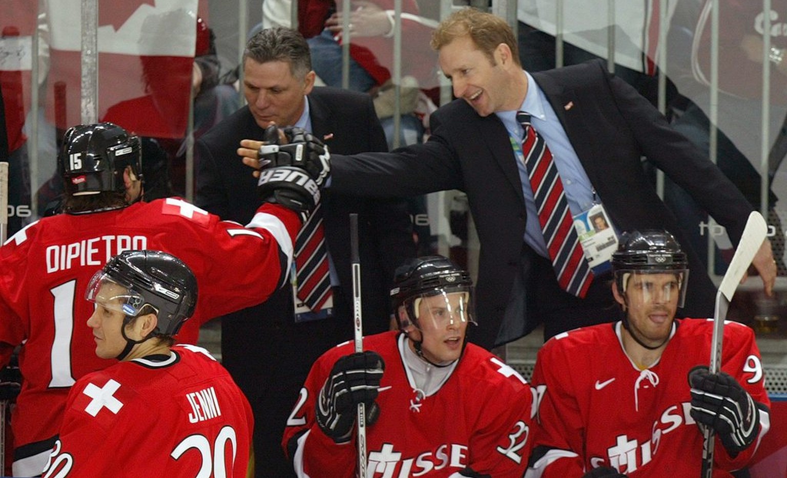 Swiss head coach, Canadian-German Ralph Krueger, right, congratulates his forward Paul di Pietro, left, who just scored his first of two goals, next to assistant coach Canadian Peter John Lee, center, ...