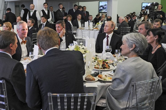 FILE- In this file photo taken on Thursday, Dec. 10, 2015, Russian President Vladimir Putin, center right, with retired U.S. Lt. Gen. Michael T. Flynn, center left, and Serbian filmmaker Emir Kusturic ...