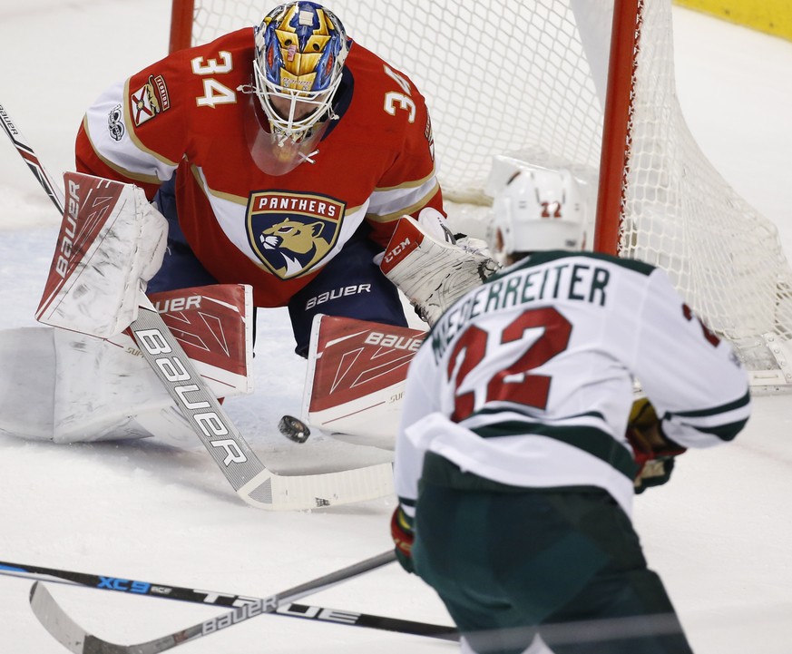Minnesota Wild right wing Nino Niederreiter (22) attempts a shot at Florida Panthers goalie James Reimer (34) during the first period of an NHL hockey game, Friday, March 10, 2017, in Sunrise, Fla. (A ...