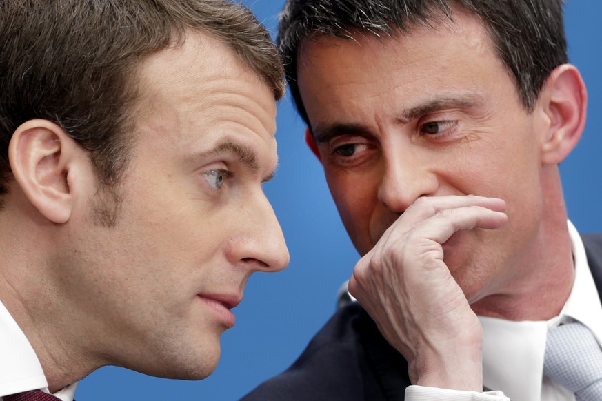 FILE - In this April 8, 2015 file photo, then French prime minister Manuel Valls, right, speaks with then economy minister Macron during in Paris. Valls suggested Tuesday May 9, 2017 that he wants to  ...