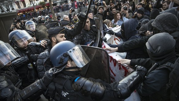 epa05802096 French riot police clashes with protesters during a demonstration to support Theo and against police violence in Paris, France, 18 February 2017. Theo, a young man, was hospitalised for an ...