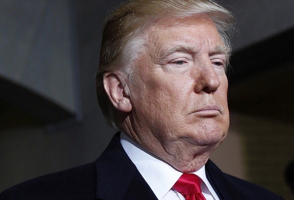 President-elect Donald Trump pauses as he waits to be introduced on the West Front of the U.S. Capitol on Friday, Jan. 20, 2017, in Washington, for his inauguration ceremony as the 45th president of t ...