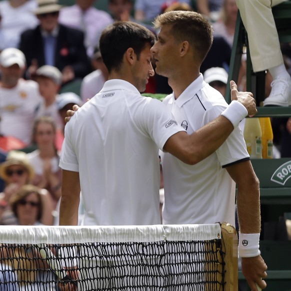 Serbia&#039;s Novak Djokovic, left, embraces Slovakia&#039;s Martin Klizan after winning their Men&#039;s Singles Match on day two at the Wimbledon Tennis Championships in London Tuesday, July 4, 2017 ...