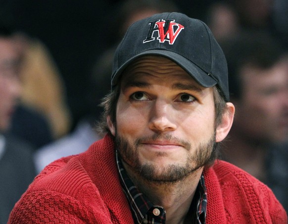 Actor Ashton Kutcher sits courtside at the Los Angeles Lakers against Denver Nuggets NBA Western Conference quarter-final basketball playoff game in Los Angeles, California in this file photo taken Ma ...