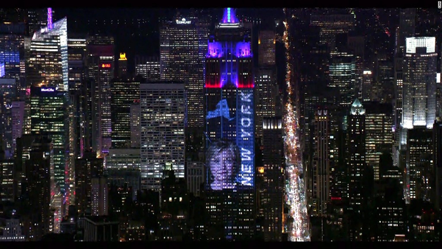 epa05623373 A handout picture made available by the Empire State Realty Trust shows a view of the Empire State Building lit with real-time election results and campaign photos during the US Election D ...