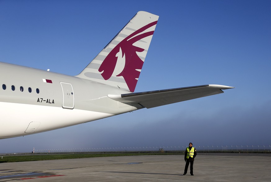 epa06012928 (FILE) - A security guard walks next to the plane before a ceremony for the delivery of the first Airbus A350 XWB to Qatar Airways in Colomiers, Southern France, 22 December 2014. Qatar Ai ...