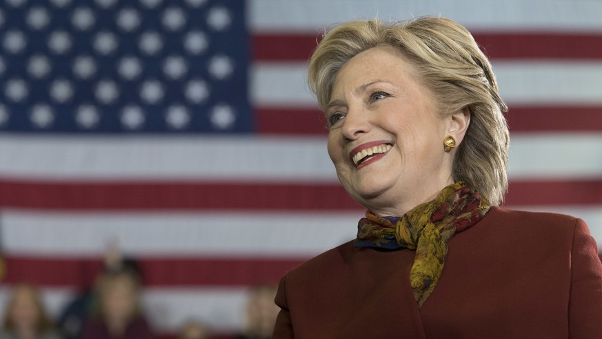 Democratic presidential candidate Hillary Clinton listens as vice presidential candidate Sen. Tim Kaine, D-Va. speaks during a campaign event at the Taylor Allderdice High School, Saturday, Oct. 22, 2 ...