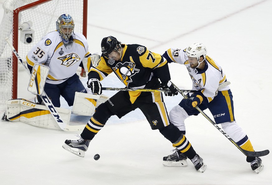 Nashville Predators&#039; Roman Josi (59) checks Pittsburgh Penguins&#039; Evgeni Malkin (71) in front of Predators goalie Pekka Rinne (35) during the second period in Game 2 of the NHL hockey Stanley ...