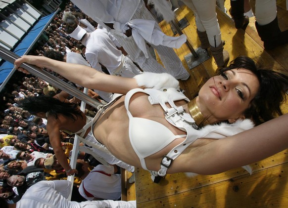 A member of the Power Dance Group dances on a love mobile at the Street Parade in Zuerich, Switzerland, Saturday, August 12, 2006. In addition to the 32 Love Mobiles this year's Street Parade inc ...