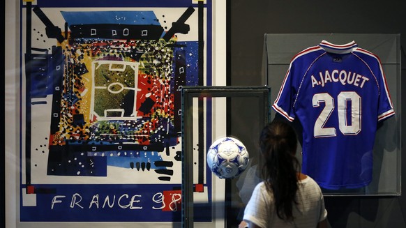 epa04286860 A visitor looks at the shirt of retired French football coach and former player Aime Jacquet and the ball of FIFA World Cup 1998 won by France, at the National Sport Museum in Nice, France ...