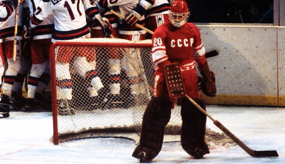 As USSR backup Goalie Vladislav Tretjak (20) contemplates his team&#039;s loss, Team USA celebrate their 4-3 upset defeat of the Soviets at the XIII Winter Olympics on February 22, 1980, at Lake Placi ...