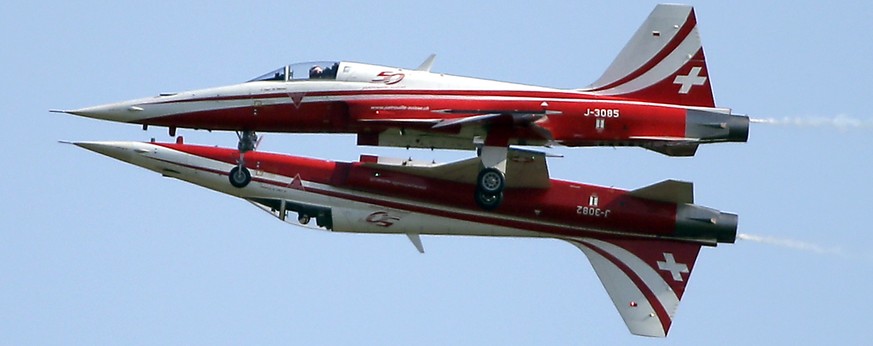 Two Northrop F-5E Tiger II airplanes of the Swiss Patrol fly close together during an aerobatic performance at the ILA Berlin Air Show in Berlin, Germany, Tuesday, May 20, 2014. The Berlin Air Show ta ...