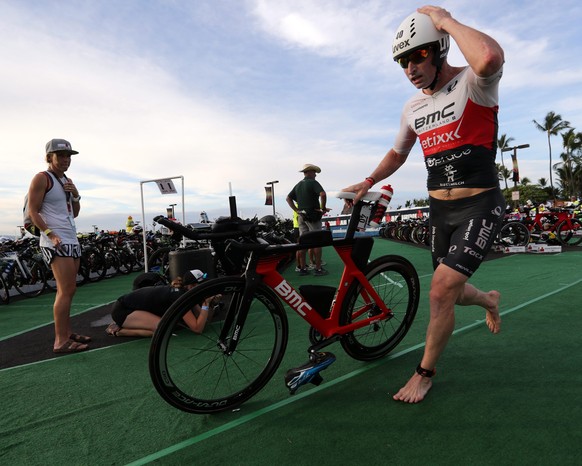 epa05577072 Ronnie Schildknecht of Switzerland, races out of the transition area to start the cycling leg of the competition of the Ironman World Championship, in Hawaii, USA, 08 October 2016. EPA/Bru ...