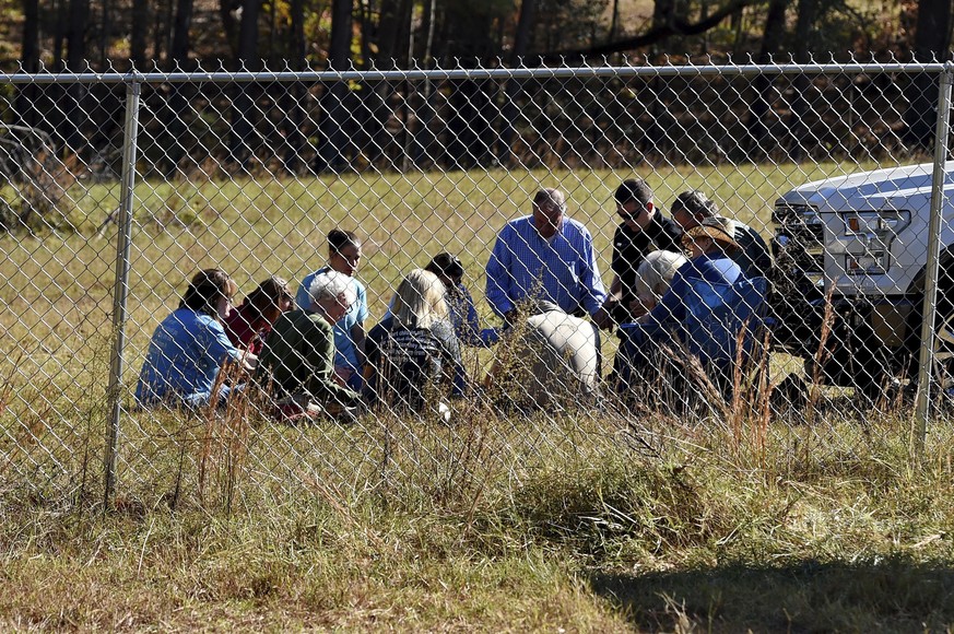 Duncan First Baptist church members,with South Carolina State Rep. Bill Chumley, hold a prayer service on Todd Kohlhepp&#039;s property in Woodruff, S.C. Monday, Nov. 7, 2016. Kohlhepp was arrested fo ...