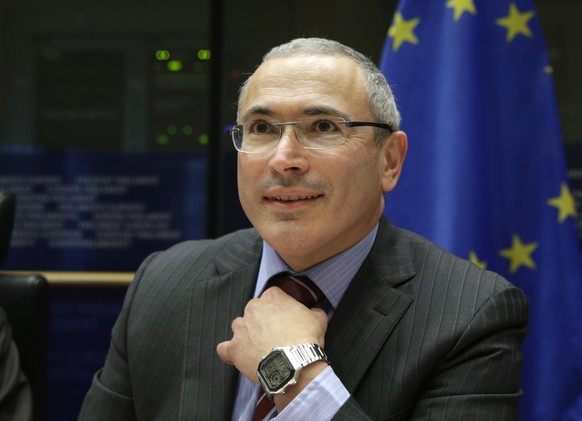 FILE - In this Dec. 2, 2014 file photo, Mikhail Khodorkovsky smiles in Brussels, Belgium. Police raided the Moscow office Thursday April 27, 2017 of an organization founded by a top foe of President V ...