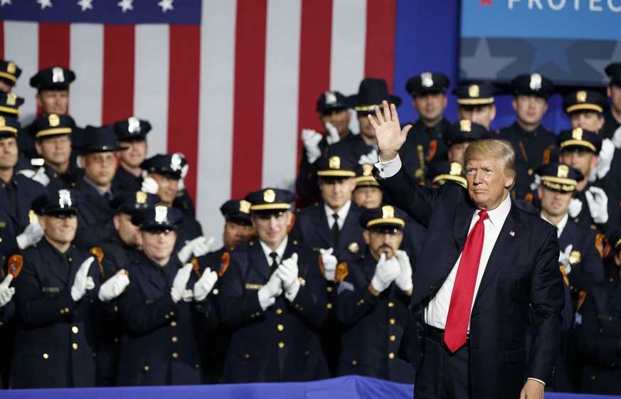 President Donald Trump waves after speaking to law enforcement officials on the street gang MS-13, Friday, July 28, 2017, in Brentwood, N.Y. (AP Photo/Evan Vucci)