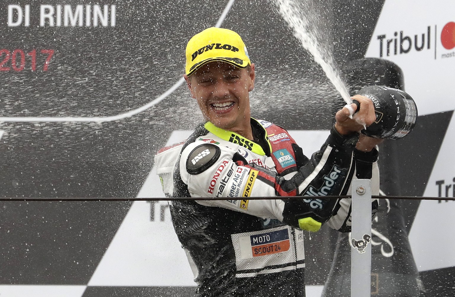 Moto 2 rider Dominique Aegerter of Switzerland celebrates on the podium after winning the San Marino Motorcycle Grand Prix at the Misano circuit in Misano Adriatico, Italy, Sunday, Sept. 10, 2017. (AP ...