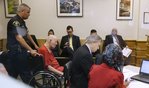 Charles Emery, second from left, is brought into court in a wheelchair as he appears for an arraignment hearing, Thursday, Aug. 31, 2017, in Seattle. Emery is one of three elderly brothers facing chil ...