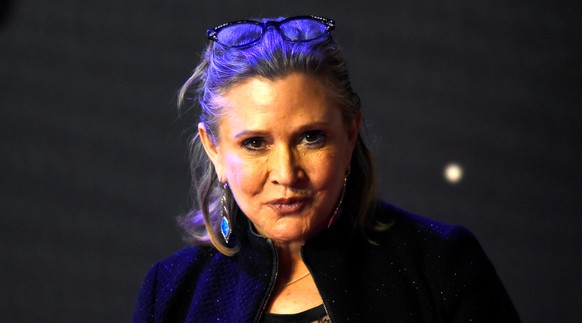 FILE PHOTO - Carrie Fisher poses for cameras as she arrives at the European Premiere of Star Wars, The Force Awakens in Leicester Square, London, December 16, 2015. REUTERS/Paul Hackett/File Photo