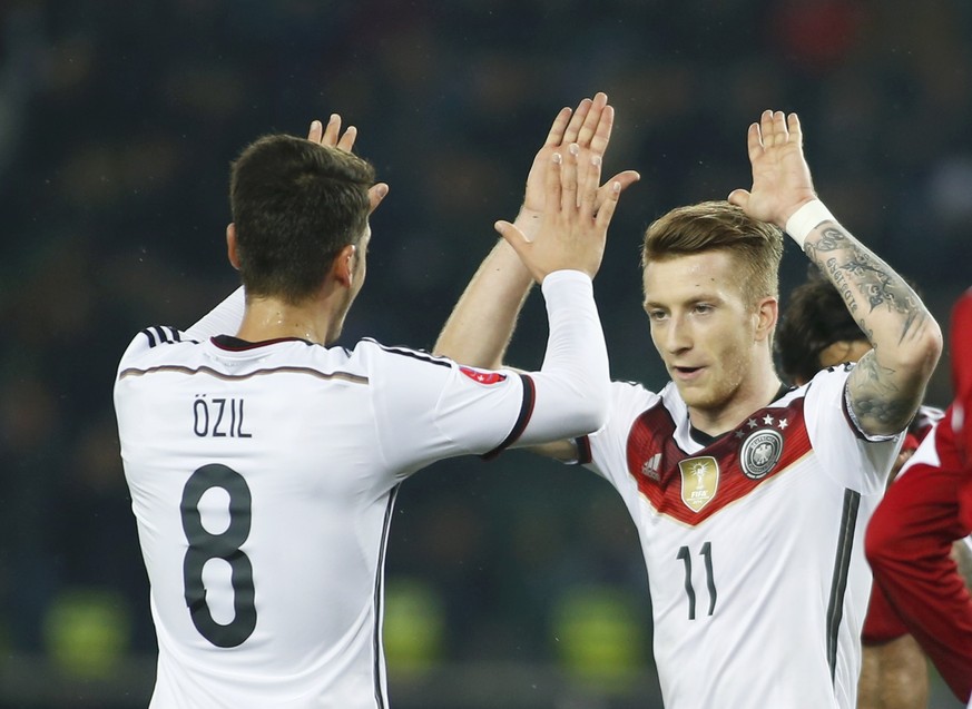 Reus klatscht nach seinem Tor mit Özil ab.