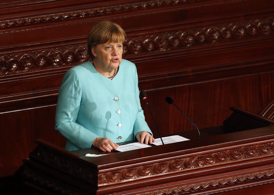 epa05827296 German Chancellor Angela Merkel delivers a speech at the Tunisian Constituent Assembly in Tunis, Tunisia, 03 March 2017. Merkel is on a one-day official visit to Tunisia. EPA/MOHAMED MESSA ...