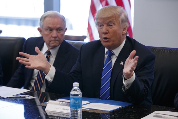 Sen. Jeff Sessions, R-Ala., left, looks on as Republican presidential candidate Donald Trump speaks during a national security meeting with advisors at Trump Tower, Friday, Oct. 7, 2016, in New York.  ...