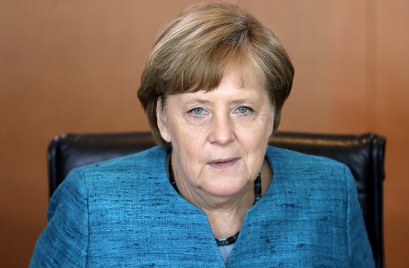 German Chancellor Angela Merkel smiles as she arrives for the weekly cabinet meeting at the Chancellery in Berlin, Germany, Wednesday, May 17, 2017. (AP Photo/Michael Sohn)