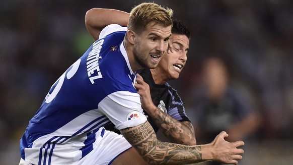 Real Madrid&#039;s James Rodriguez, right, fights with Real Sociedad&#039;s Inigo Martinez during the Spanish La Liga soccer match between Real Madrid and Real Sociedad, at Anoeta stadium in San Sebas ...