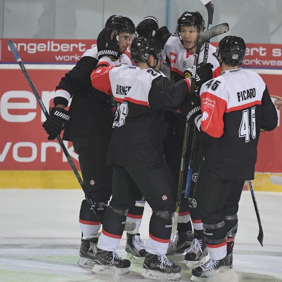 Fribourg&#039;s Alexandre Picard, Julien Sprunger and Michal Birner, from right, celebrate the first Goal during the ice hockey Champions League match 1/4 Final between HC Fribourg-Gotteron and Vitkov ...