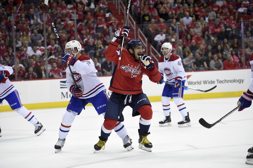 Washington Capitals left wing Alex Ovechkin (8), of Russia, celebrates his goal next to Montreal Canadiens defenseman Karl Alzner (22) during the first period of an NHL hockey game, Saturday, Oct. 7,  ...