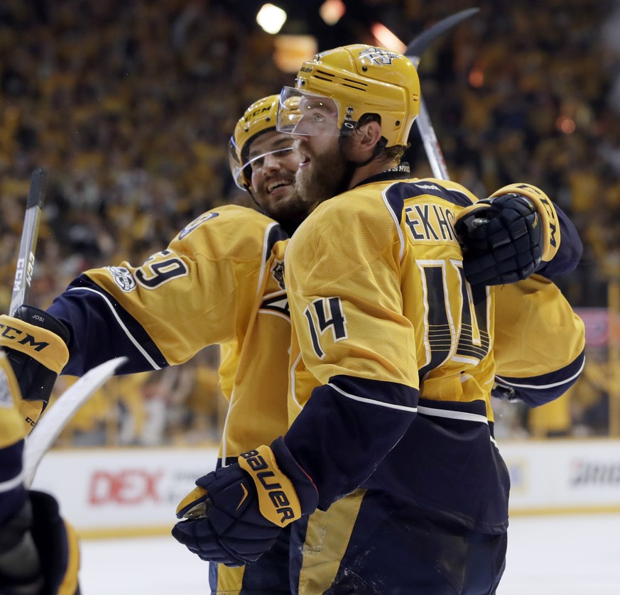 Nashville Predators defenseman Mattias Ekholm (14), of Sweden, celebrates his goal against the Pittsburgh Penguins with defenseman Roman Josi (59), of Switzerland, during the third period in Game 3 of ...