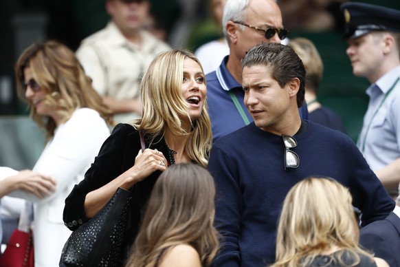 German model Heidi Klum, left, and Vito Schnabel, right, watch the semifinal match of Roger Federer of Switzerland against Milos Raonic of Canada, at the All England Lawn Tennis Championships in Wimbl ...