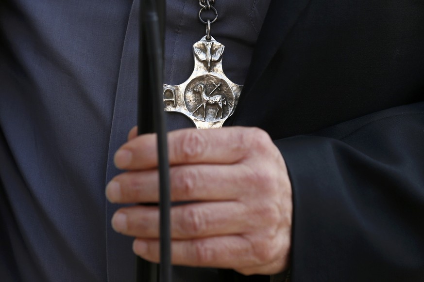 A crucifix is worn by the Archbishop of Rouen and Primate of Normandy Mgr Dominique Lebrun is seen talks to the media after a meeting with French President Francois Hollande (not pictured) at the Elys ...