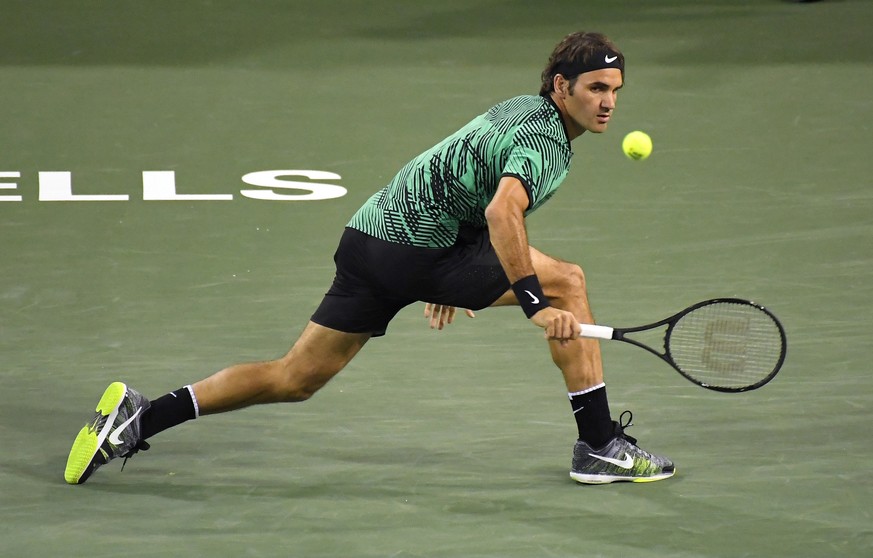 Roger Federer, of Switzerland, returns a shot to Stephane Robert, of France, at the BNP Paribas Open tennis tournament, Sunday, March 12, 2017, in Indian Wells, Calif. Federer won 6-2, 6-1. (AP Photo/ ...