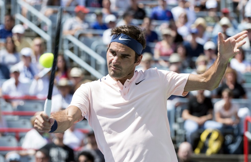 Roger Federer of Switzerland returns to Peter Polansky of Canada at the Rogers Cup tennis tournament, Wednesday, Aug. 9, 2017 in Montreal. (Paul Chiasson/The Canadian Press via AP)