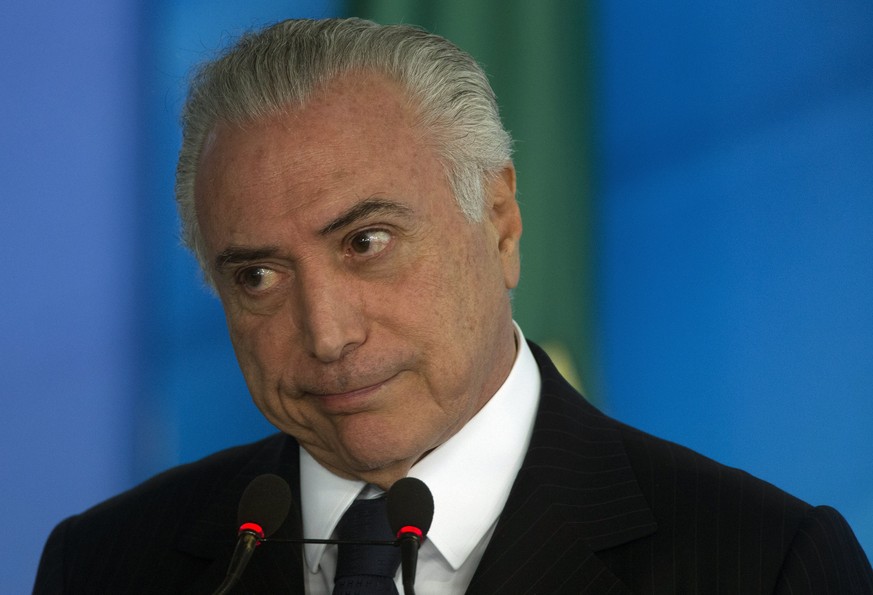 epa06051599 Brazilian President Michel Temer attends a ceremony to sanction the law that regulates price differentiation in Planalto Palace, in Brasilia, Brazil, 26 June 2017. Pressure intensifies on  ...