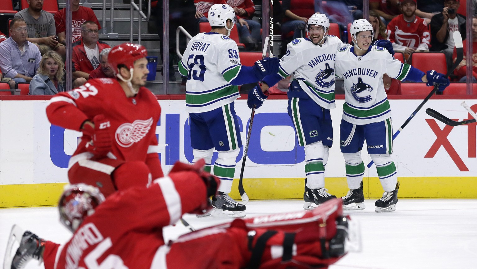 Vancouver Canucks left wing Sven Baertschi (47), of Switzerland, second from right, celebrates his goal against the Detroit Red Wings with center Bo Horvat (53) and defenseman Troy Stecher, right, as  ...