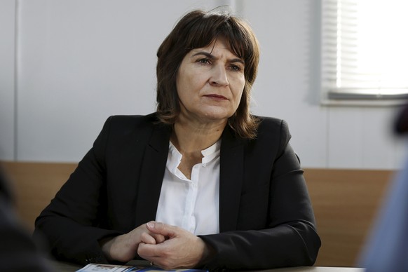 Netherlands Minister of Foreign Trade and Development Cooperation Lilianne Ploumen listens to the U.N. staff during her visit to the Al Zaatari refugee camp in the Jordanian city of Mafraq, near the b ...